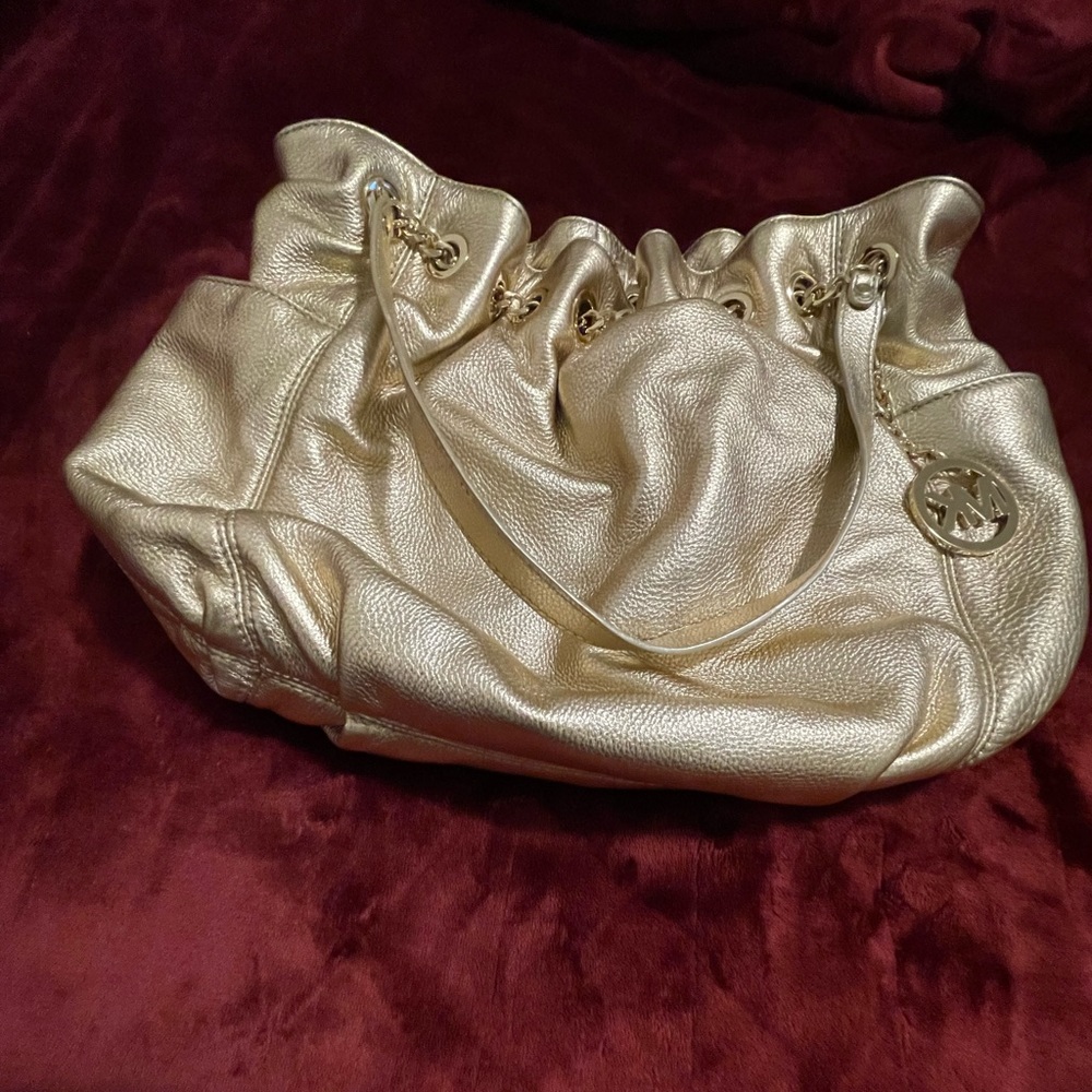 Michael Kors Gold purse, w/gold chains & gold circle loops with protective cover